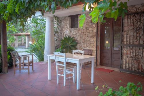 a white table and chairs on a patio at B&B Lucamaria in Trepuzzi