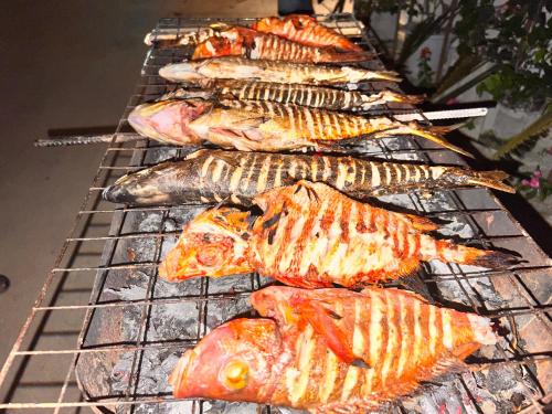 a bunch of fish are cooking on a grill at Manta Stay Thoddoo, Maldives in Thoddoo