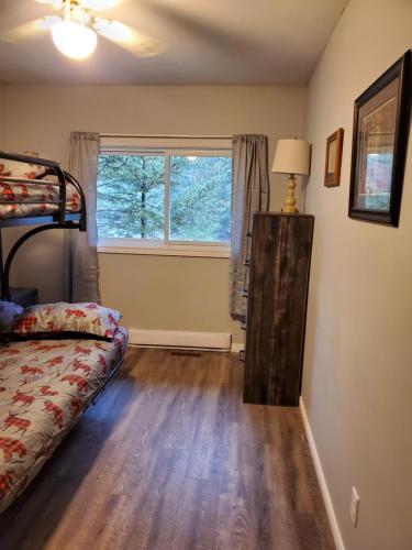 a bedroom with a bed and a window at Michaels Bay Getaway on Manitoulin Island in South Baymouth