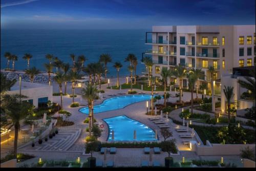 an aerial view of a resort with a swimming pool at Apartment the address resort- Two-Bedroom and maid room in Al Aqah