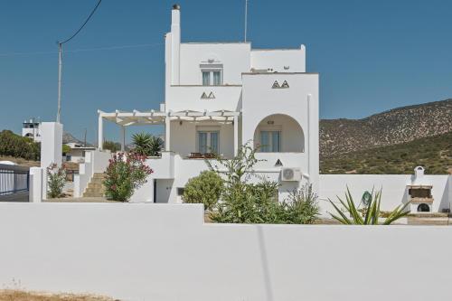 a white building with plants on the side of it at Ocean Blue Villa in Agiassos