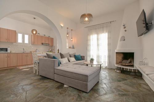 a living room with a couch and a fireplace at Ocean Blue Villa in Agiassos