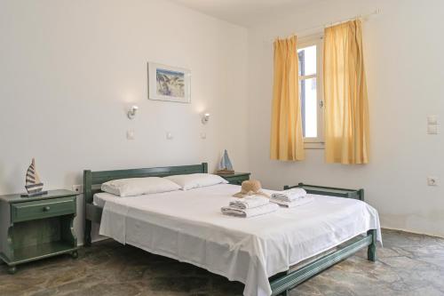 a bedroom with a bed with a teddy bear on it at Ocean Blue Villa in Agiassos