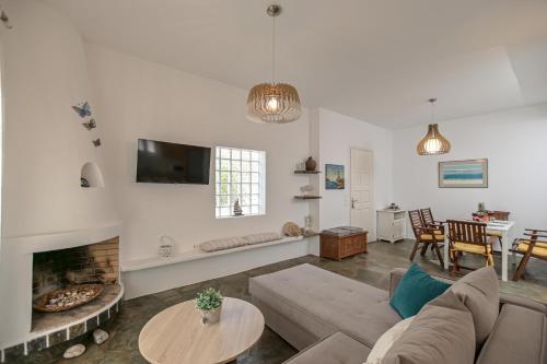 a living room with a couch and a fireplace at Ocean Blue Villa in Agiassos