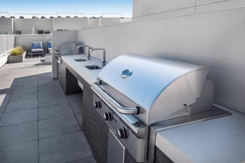 a kitchen with a sink and a counter top at Sky-Rise Apartments in Los Angeles