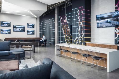 a man sitting at a piano in a waiting room at Sky-Rise Apartments in Los Angeles