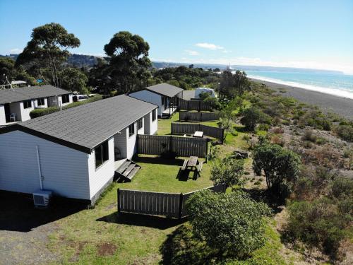 an overhead view of a row of mobile homes next to the beach at Napier Beach Top 10 Holiday Park & Motels in Napier