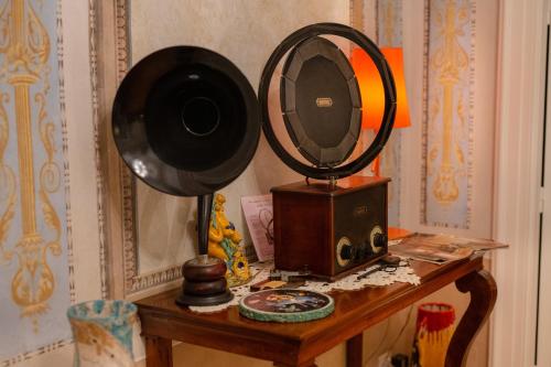 a table with a mirror and a speaker on it at Palazzo Suriano Heritage Hotel in Vietri sul Mare