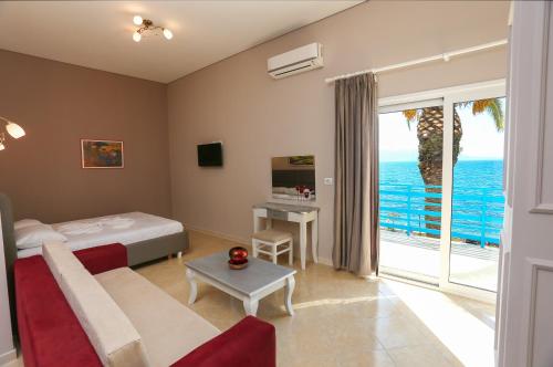 a bedroom with a bed and a view of the ocean at Apartments Serxhio in Sarandë
