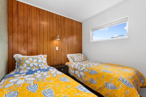 a small bedroom with a bed and a window at Matapouri Magic - Matapouri Holiday Home in Matapouri