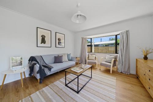 a living room with a couch and a table at Greytown Getaway - Greytown Holiday Home in Greytown