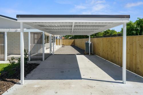 a white pergola over a driveway at Greytown Getaway - Greytown Holiday Home in Greytown