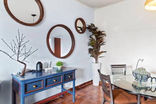 a blue dresser in a dining room with a table and a mirror at +MS +Suite Confortable Ubicación + Zaragoza C31 in Casa Blanca La Corregidora