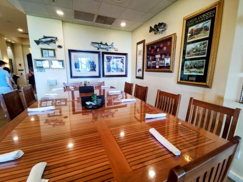 a dining room with a large wooden table and chairs at GreenLinks Luxury Villa at Lely Resort Golf - 3 Bedrooms in Naples