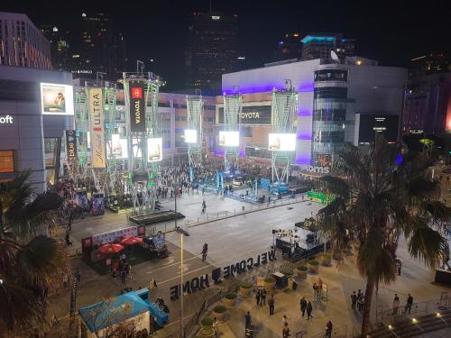 a city street at night with people and buildings at Sky-Rise Apartments in Los Angeles