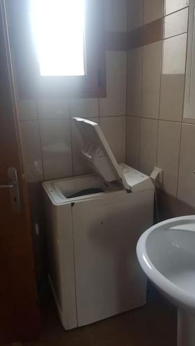a small bathroom with a sink and a toilet at Rena's house in Pachia Ammos