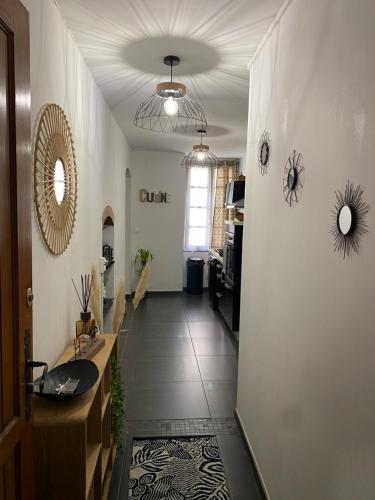 a hallway with a sink and a mirror on the wall at Appartement F3 hyper centre in Ajaccio