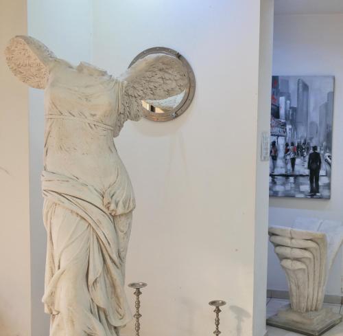 a statue of a woman looking in a mirror at City of Art Venice LLoyd in Marghera