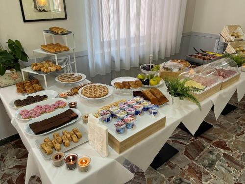 a table filled with different types of pastries and desserts at Hotel Venere in Rimini