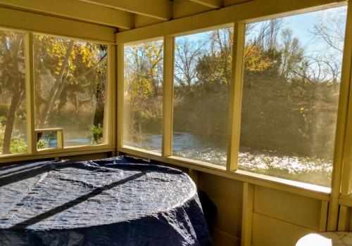 a bedroom with a bed and two windows at Billingsley Creek in Hagerman