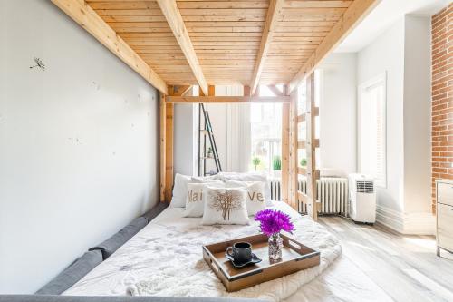 a room with a bed with a tray on it at NB Urban Luxury Suites in Toronto