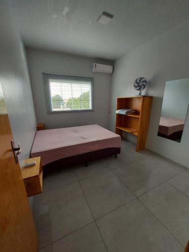 Tempat tidur dalam kamar di Residencial Baldissera e Zeni
