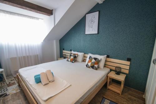 a bedroom with a large bed and a green wall at A lovely 2-bedroom apartment in central Tbilisi in Tbilisi City