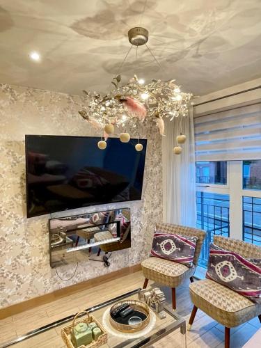 a living room with a flat screen tv on a wall at Waterfront Villa Marina SA1 Swansea in Swansea