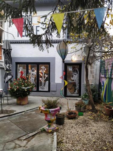 a house with some flags and flowers in front of it at Good People Design Hostel in Belgrade