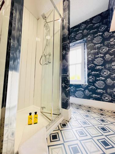 a bathroom with two bottles of yellow shampoo at Central located house for big groups in Bristol