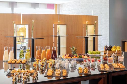 a buffet with many different types of food and drinks at NH Leipzig Messe in Leipzig