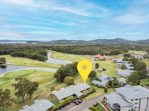 an aerial view of a golf course with a yellow marker at Villa 121 Horizons in Salamander Bay