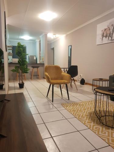 a living room with a chair and a table at Menlyn Place in Pretoria