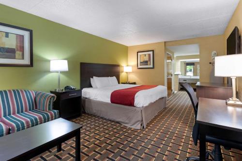 a hotel room with a bed and a couch at SureStay Hotel by Best Western Lenoir City in Lenoir City