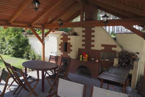 a patio with a brick fireplace and a table and chairs at WIlla Maksymilian Bed and Breakfast in Bydgoszcz