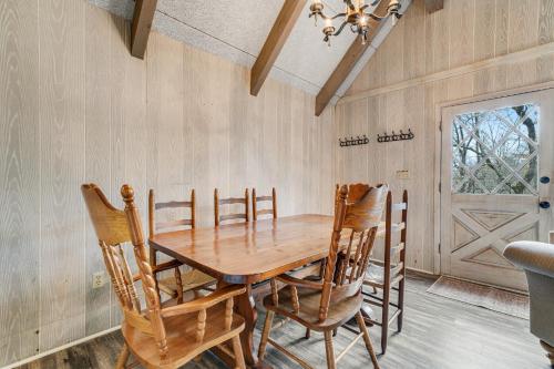 a dining room with a wooden table and chairs at High Charter in Beech Mountain