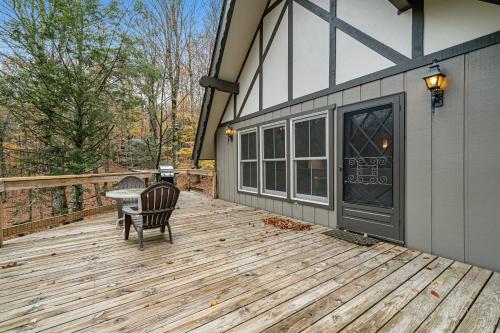 a patio with a table and a chair on a deck at High Charter in Beech Mountain