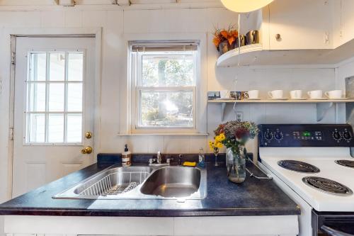 a kitchen with a sink and a stove at The Lake House in Plymouth