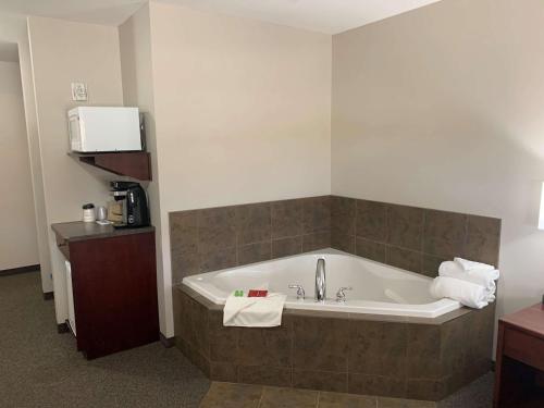 a large bath tub in a hotel room at SureStay Plus Hotel by Best Western Hardisty in Hardisty