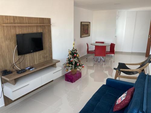 a living room with a christmas tree and a television at Vidigal Sol in Rio de Janeiro