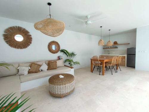 a living room with a table and a dining room at Kalea Villas in Kuta Lombok