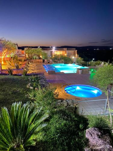 a group of three swimming pools at night at Valle Las Piedras in Arroyo de Los Patos