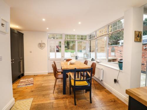 a dining room with a table and chairs at The Willows in Melton Mowbray