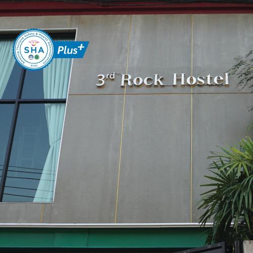 a sign on the side of a building at Third Rock Hostel in Bangkok