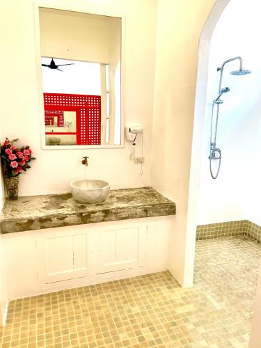 a bathroom with a sink and a mirror at Watercolours in Ko Chang