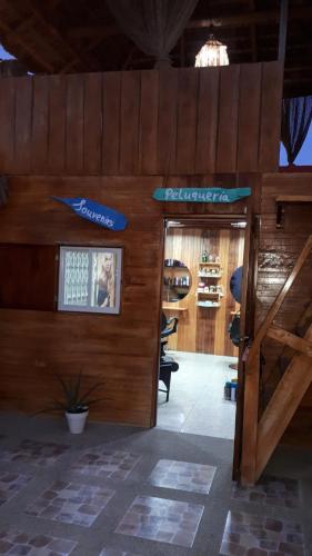 a wooden building with a entrance to a store at Hostal Villa Brisa in Ballenita