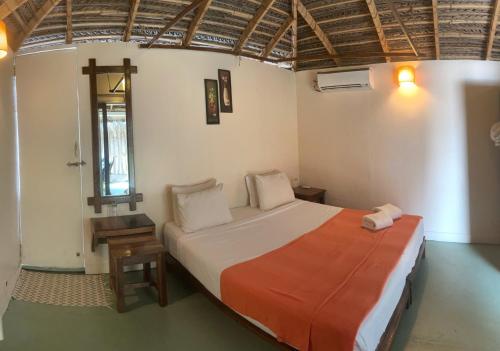
A bed or beds in a room at Agonda Beach Resort
