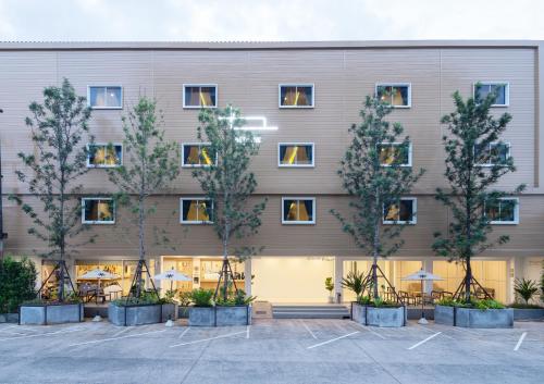 プーケットタウンにあるBedline Hotel - SHA Certifiedの中庭の木々のある建物の外観