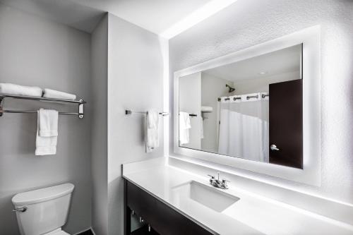 a white bathroom with a sink and a mirror at Holiday Inn Express & Suites Austin NW – Lakeway by IHG in Lakeway