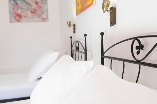 two beds in a white bedroom with white walls at Spacious Studios Lefkada Mountain View Near Beach in Dhráganon